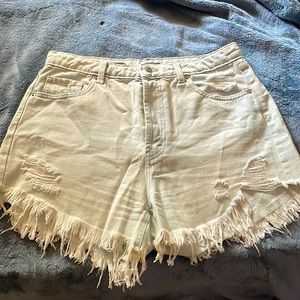 Light colored ripped style shorts